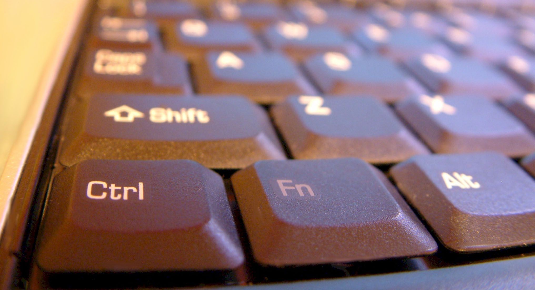 A close up of the lower left corner of black keyboard with white lettering. The first three keys on the bottom row are 'Ctrl', 'Fn', and 'Alt'.
